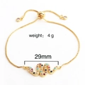 Detail of adjustable gold snake bracelet with colorful cubic zirconia and sliding clasp - Snake Style 2