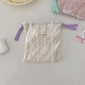 Detail of cream velvet drawstring pouch with lace trim and purple ribbon ties - Purple Drawstring / White