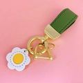 Green leather keychain with gold metal hardware and white floral pendant on pink base - Green Leather [White Flower]