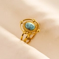 Detail of gold vintage ring featuring an oval turquoise stone with bead halo accents - Gold Base Blue Turquoise Texture