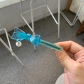 Detail of blue acetate hair clip featuring a floral bow design and a white pearl pendant - Lake Blue Bow