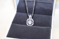 Macro detail of silver square zircon necklace pendant on dark grey velvet lining - Square Zirconia Necklace