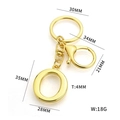 Golden stainless steel letter O keychain with size dimensions and weight specifications - Letter O