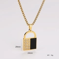 Macro detail of gold lock pendant showing crystal pavé and black inlay with dimensions - Black and Gold Lock Style