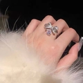 Elegant silver-toned bow ring with pear-cut center stone and pave zircon on finger - White Gold Ljz-249 / Adjustable Open