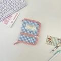 Close-up of blue and white plaid quilted mini binder cover with pink zipper and logo label - Light Blue