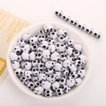 White acrylic skull beads for DIY jewelry making displayed in a decorative bowl - 10x12mm White With Black Skull (50pcs)