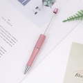 Pink matte beaded ballpoint pen with a sleek metallic retractable stem and silver tip - Pink