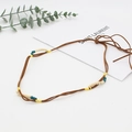 Detail view of Bohemian braided leather hat band with turquoise beads on white background - Brown Multi-strand Braided Beaded Style (6)
