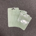 Detailed view of matte light green frosted resealable bags with hanging holes in various sizes - Green (16x24cm)