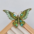 Vintage gold butterfly brooch featuring emerald green crystals and rhinestones - Vintage Gold Green Butterfly