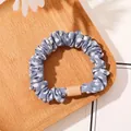 Close-up of a light blue polka dot scrunchie with a stylish square resin charm detail - Satin Polka Dot Light Blue