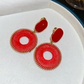 Close-up of red woven round drop earrings with gold textured frames and oil-drip detail - Clip-on Earrings / Gold-Red