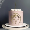Detail of 9.5cm gold acrylic baby shower cake topper showing hands holding baby feet - Hands Holding Feet Style 1 / Gold