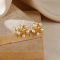 Vintage golden starfish stud earrings with white pearls on a minimalist stone display - Hexagram Pearl