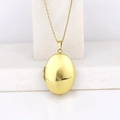 Polished gold oval locket necklace on white marble block, minimalist jewelry photo - Oval Smooth 30*24/Gold