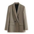 Detailed close-up of brown houndstooth blazer showing flap pockets and single button - Plaid