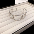 Close-up of polished silver chunky chain cuff bracelet with oval interlocking links - Silver
