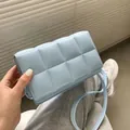 Minimalist light blue woven crossbody bag featuring a large quilted weave and slim strap - Light Blue