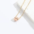 Minimalist rose gold necklace featuring a polished cylindrical pendant on a fine chain - Rose Gold Cylinder / Rose Gold