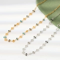 Close-up of gold and silver thin chain necklaces with colorful enamel bead details - Gold Blue