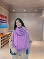 Elegant purple wool cashmere scarf with tassels draped on model for winter styling - Medium Purple