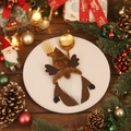 Christmas gnome cutlery holder with reindeer horns on a white plate with golden utensils - Elk Style