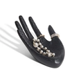 Matte black hand-shaped jewelry display stand with embossed floral patterns for rings - Black