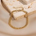 Golden Cuban chain bracelet with heart charm and lobster clasp on beige stone - Gold Flat Curb Chain (0070-7)
