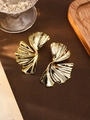 Macro detail of vintage gold textured ginkgo leaf earrings on a lifestyle background - S4234-1 Style