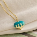 Close-up of golden lava heart pendant with blue enamel drip on elegant chain necklace - Blue