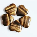 Polished tiger eye heart stones with natural golden-brown chatoyant stripes on white background - Tiger Eye Stone Bracelet