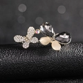 Detailed close-up of a silver butterfly brooch with rhinestones and cat-eye stones - Crystal Butterfly Brooch