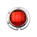 Detail eines faltbaren runden Taschenhalters mit rotem Edelstein in Silberoptik - Rot