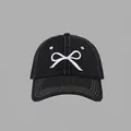 Detail of white bow embroidery and contrast stitching on a black denim baseball cap - Denim Bow Baseball Cap Style / Black