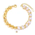 Close-up of double-layered gold bracelet with pearls and a crystal heart pendant - Pig Nose Chain & Rectangle Crystal Pearl