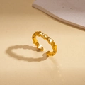 Macro detail of a 24k gold-plated open ring featuring a geometric undulating wave design - Heart Wave Style