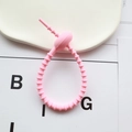Pink silicone cable organizer tie with adjustable notches for desk wire management - Pink