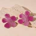 Detailed view of pink gradient rhinestone flower earrings on stone steps decoration - Pink