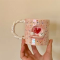 Detail of pink pearlescent ceramic mug with relief white puppy and red heart design - Heart Dog