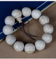 Detailed close-up of natural camphor wood prayer beads with delicate wood grain and knots - 20mm*12 Beads Three-way Style