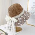 Straw sun hat with white floral lace embroidery and large ribbon bow on elegant stand - Khaki