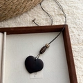 Detail view of a handcrafted dark brown heart wood pendant in an elegant jewelry box - 14# Brown Heart