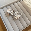 Macro view of silver geometric hollow flower earrings with pleated metal texture on velvet - 37# Silver Irregular Pleated Metal Ear Cuff
