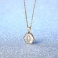 Hexagonal white shell pendant necklace in golden stainless steel featuring letter Q - Letter Q
