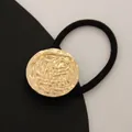 Minimalist elastic hair tie with textured golden metal ring in black and gold - Round Lava Rock Gold