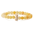 Detail of yellow stone beads with ice crack patterns and dolphin charm on elastic bracelet - Yellow Weathered Stone