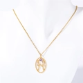 Close-up of golden zodiac necklace with stylized H pendant and purple turquoise stone - Pisces