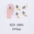 Macro shot of 3D horse-hoof flower nail charms with grey teardrop rhinestones - Gold Base Grey Black Rhinestone (AM86)