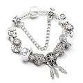 Detail of dreamcatcher pendant and silver feather charms on a DIY beaded heart bracelet - Dreamcatcher Theme (L04) / 16cm